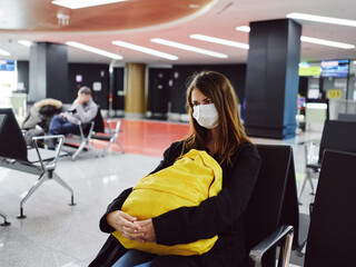 woman in medical mask airport yellow backpack waiting for flight passenger