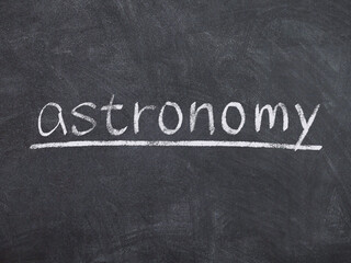 Fototapeta premium astronomy concept word on blackboard background