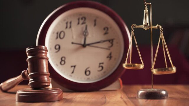 Concept showig of Problems with legal system, delay or slow in judicial justice system by using judge hammer, balance scale and wall clock.