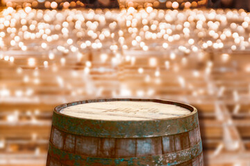 Golden lights on wooden background. Holiday banner of Wooden wine or beer barrel on light background