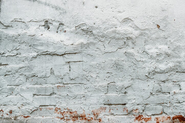 Old plastered brick wall. Urban architecture. Repairs. Collapsed brickwork. White brick background.