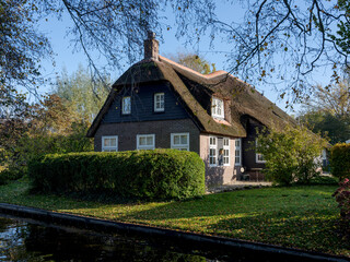 Fototapeta na wymiar Centuries-old thatched-roof houses in Giethoorn, Steenwijkerland, Overijssel Province, The Netherlands