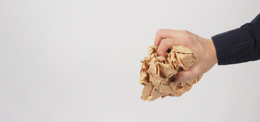 Crumpled brown paper.It is mauled in man hand on white background.