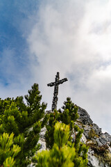 Mountain summit cross on the top of the alps