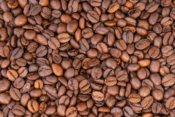 Roasted coffee beans top view, close-up. Arabica beans. Natural coffee. Coffee background.