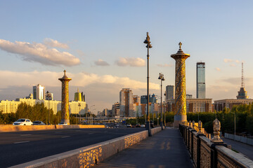 Fototapeta na wymiar View from ”Maral” bridge at Mongilik avenue in Nur-Sultan, Kazakhstan. Sunset time.