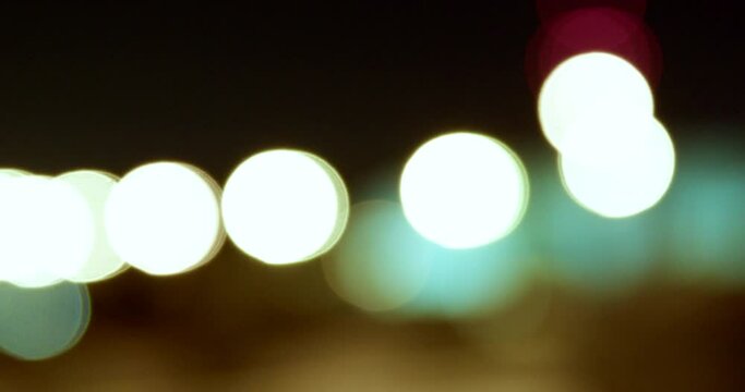 Blurred view of street lights on a desert road at night