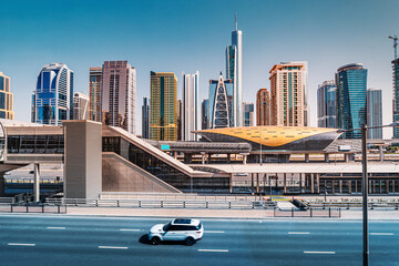 Transport communications and road infrastructure in Dubai - a passenger car rides on a high-speed...