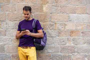 Obraz premium Young latin man with mobile phone outdoors