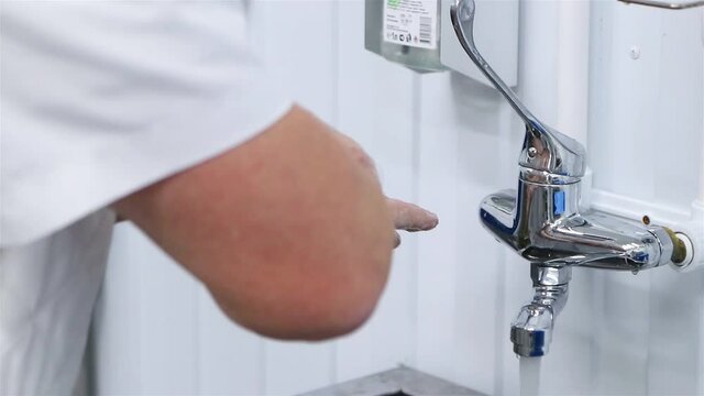 Production worker washes his hands thoroughly. 50p