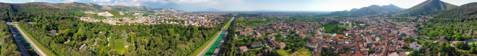 Obraz premium Reggia di Caserta, Italy. Aerial view of famous royal building gardens from a drone in summer season.