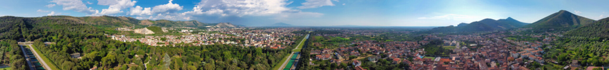 Fototapeta premium Reggia di Caserta, Italy. Aerial view of famous royal building gardens from a drone in summer season.
