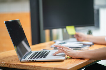 Woman working at home office hand on keyboard close up.