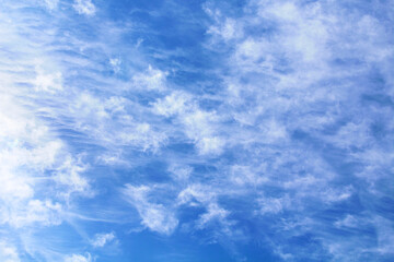 Beautiful blue sky and white cirrocumulus clouds. Spindrift clouds. Background. Texture. Scenery.