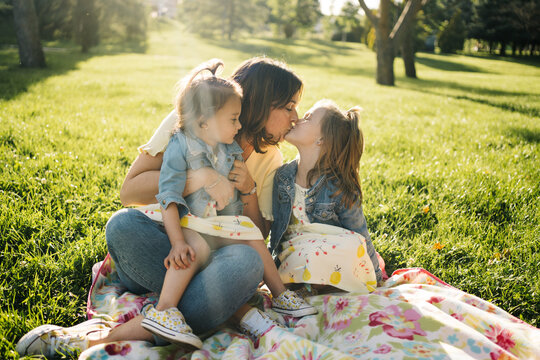 Loving mother with kids in green park