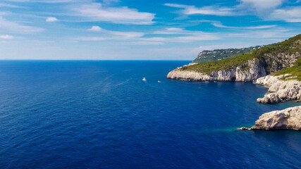 Fototapeta na wymiar Lighthouse and Beach of Capri in summer season. View from a moving drone.