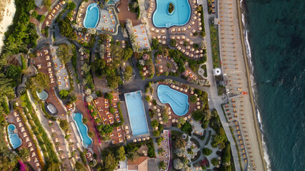 Overhead aerial view of Ischia Citara Beach at sunset with pools and sand.