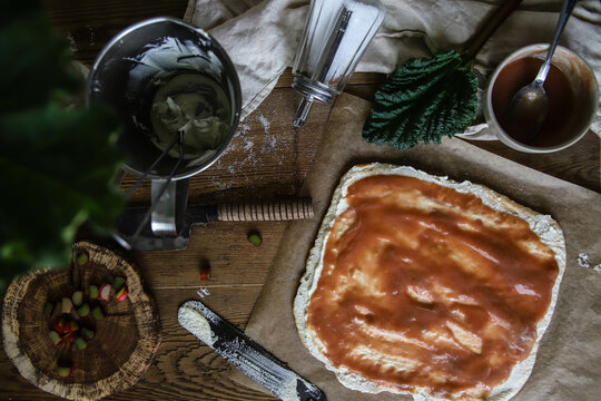 Top View Of Pizza Dough With Red Sauce And Other Inngredients