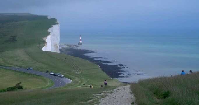 Birling Gap, Eastbourne, England - July 3 2021: The spectacular natural coastal landscape of huge white cliffs and coastal paths attract many tourists, hikers and families of all ages