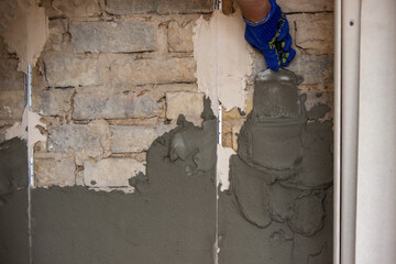 man plastering the wall. Construction, repairs in the house.