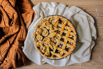 Autumn composition. Decorated apple pie on a table with flour and linen fabric. Blog, blogger and...