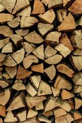 Background of dry chopped firewood. Firewood wall. Fresh wood for kindling.