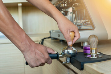 hand holding coffee powder press