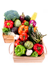 Top view of Healthy fresh vegetables in wooden boxes on white background, healthy food