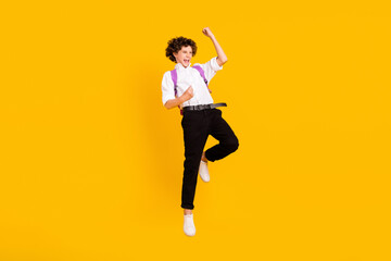 Full size photo of hooray little brunet boy jump wear uniform shoes isolated on yellow background