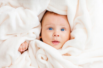 Portrait of a beautiful baby in a white towel