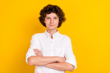 Photo of sweet confident schoolboy dressed white shirt arms crossed smiling isolated yellow color...