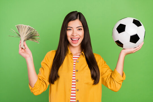 Photo of impressed rich brown hairdo millennial lady hold money ball wear yellow shirt isolated on green color background