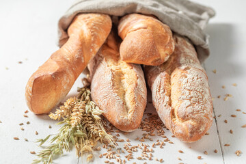 Brown baguettes made of whole grains. Country kitchen or bakery.