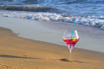Wine glass with a cocktail by the sea.