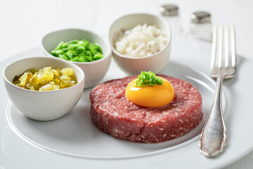 Spicy beef tartare with pepper and oil. Tatars traditional dish.
