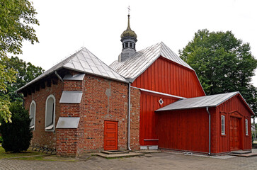 A wooden belfry and a brick chapel from the 16th century and a wooden Catholic church of Saint...