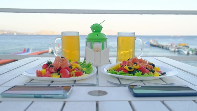 Restaurant table for two with Mediterranean cuisine against the background of the sea