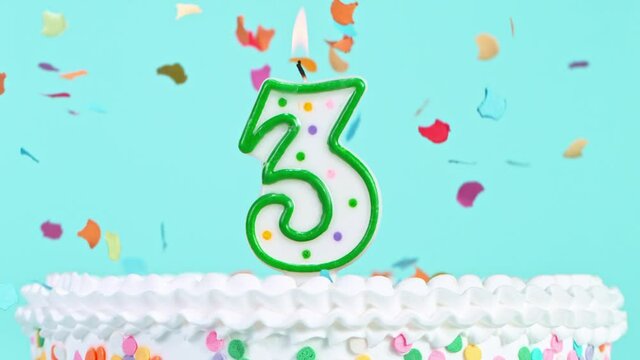 Birthday Cake With Burning Colorful Candle with Number 3 on Pastel Background. Falling confetti. Super Slow Motion, 1000 FPS.