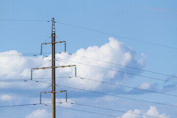 Power lines with blue sky with white clouds on sunny day at background