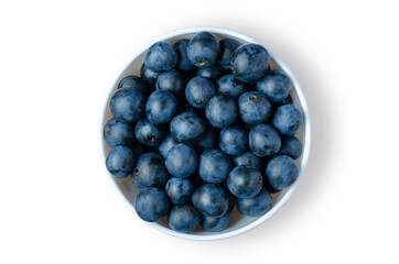Small plum. Ripe berries in a white plate. Isolated on white