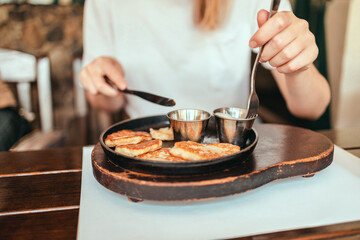 Delicious homemade vegan potato pancakes on a plate in street cafe. Traditional delicious food