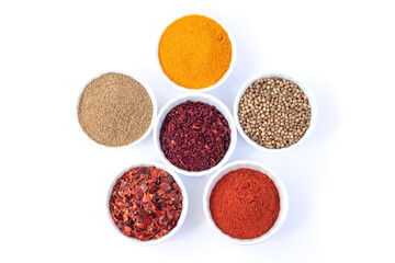 Bowls of different seasoning organic spices isolated on white