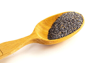 Poppy seed in wooden spoon isolated on white background.
