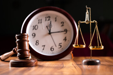 Concept showing of Problems with legal system, delay or slow in judicial justice system by using judge hammer, balance scale and wall clock. - obrazy, fototapety, plakaty