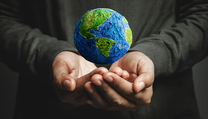 World Earth Day Concept. Green Energy, Renewable and Sustainable Resources. Environmental and Ecology Care. Hand Levitating a Green Handmade Globe