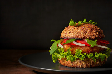 Tasty and healthy vegetarian burger with lentil's cutlet and fryed bun.