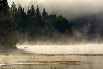 Obraz na płótnie Canvas Mist on a great lake in Quebec, Canada in the morning