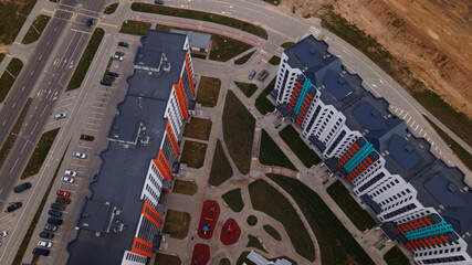 Construction site for a new city block. New houses have been built. Aerial photography.
