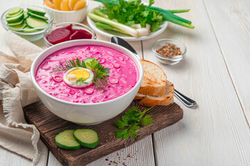 Summer, healthy beetroot soup with egg on a white background with space to copy. Side view, horizontal.