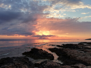 sunset on the seaside in summer with a cloudy sky